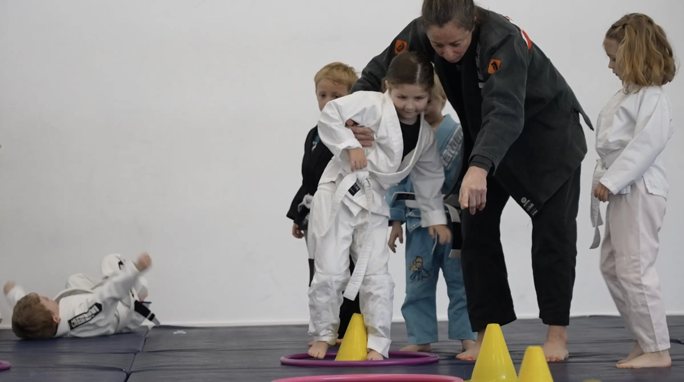 La professeure guide un atelier enfants entre les plots